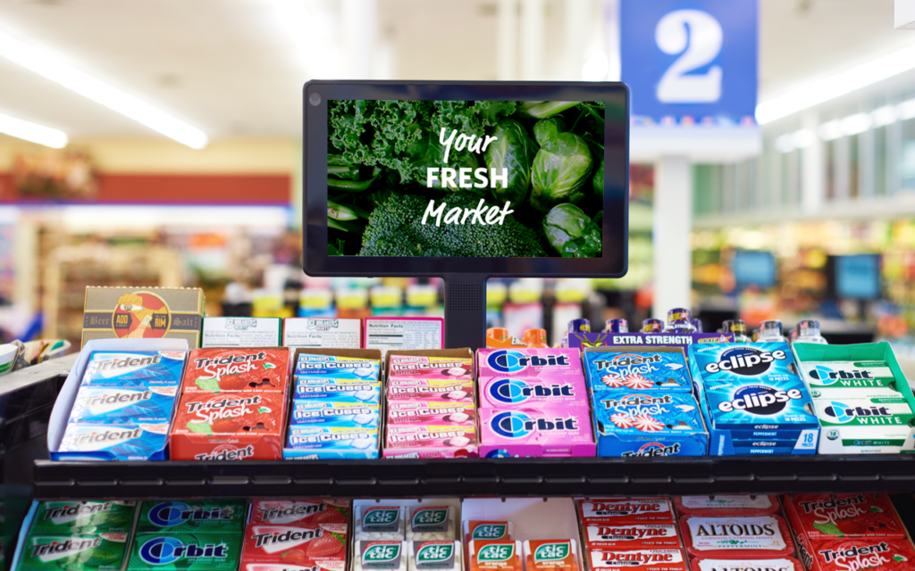 DOOH screen in grocery checkout lane.