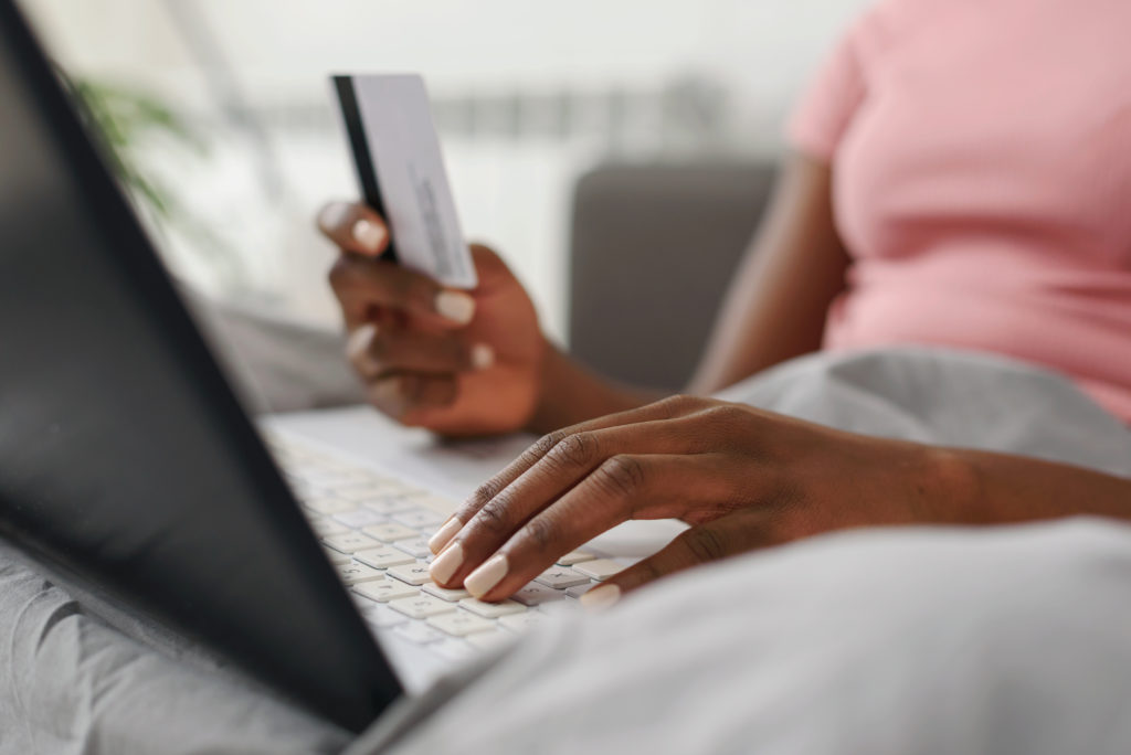 Image of woman using her computer to shop for deals and products online with digital couponing